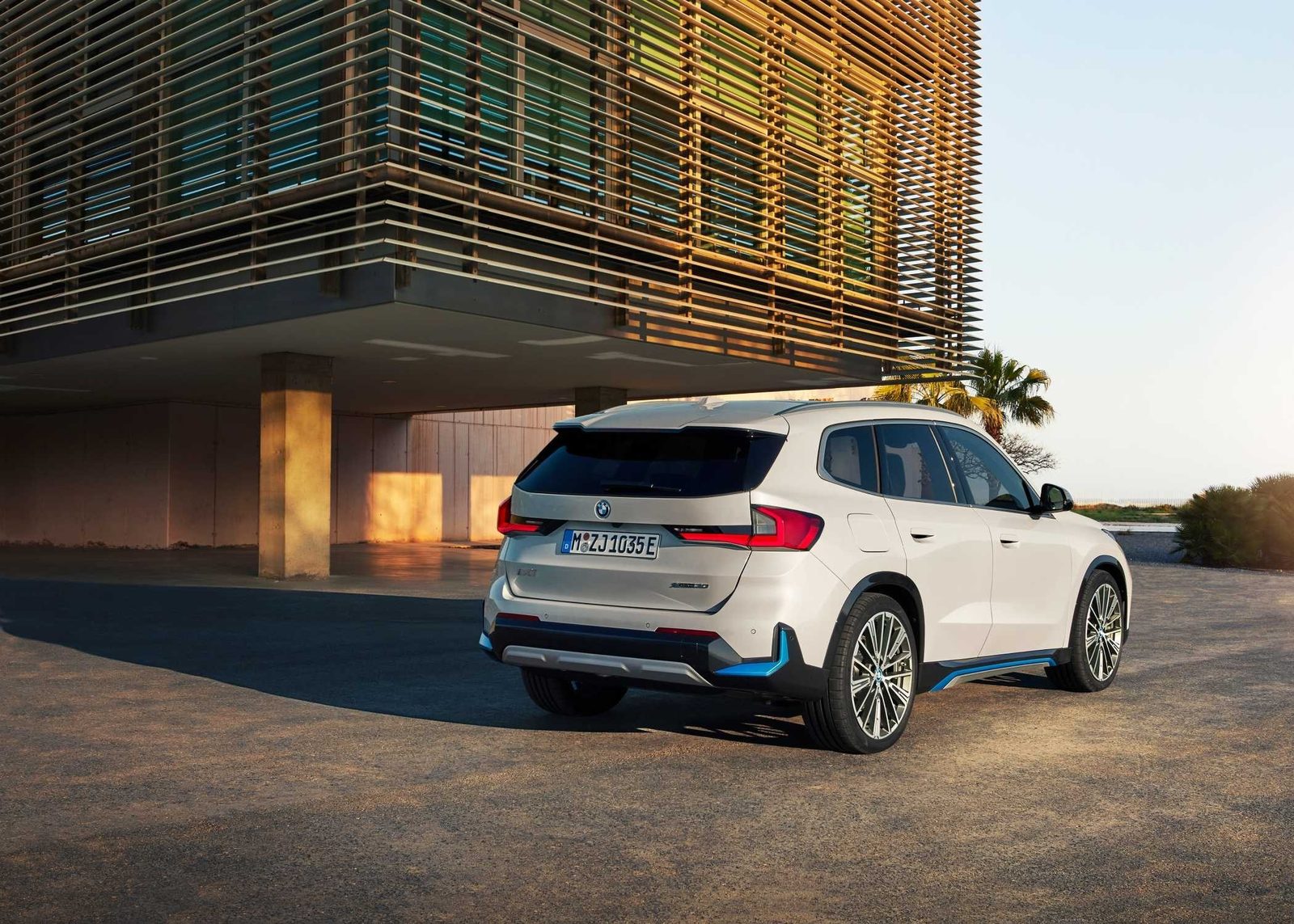 BMW iX1 Global 2022 - main model photo, exterior, rear 3q lifestyle, Global reference market