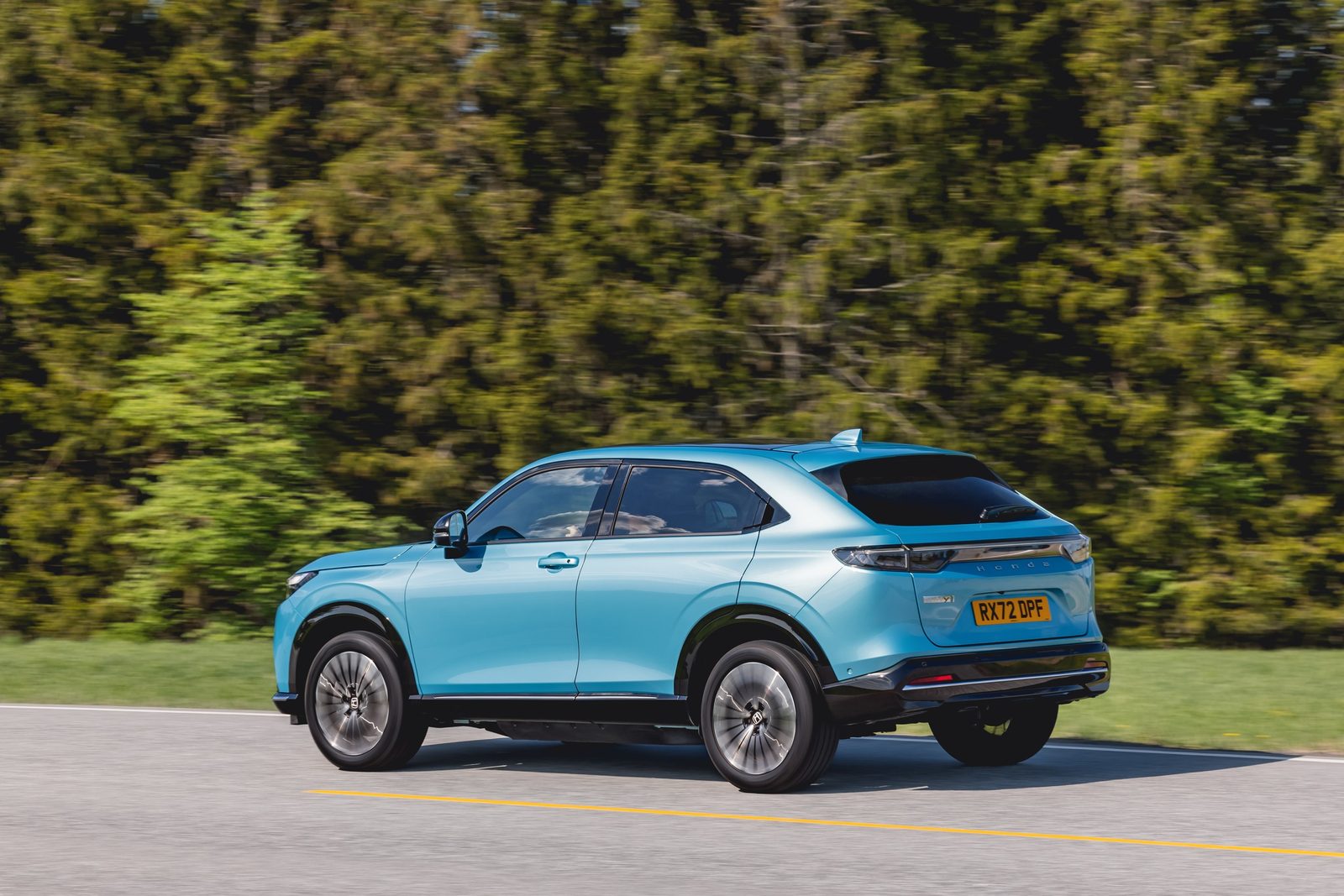 Honda e:Ny1 Global 2023 - exterior, rear 3q driving, Europe/global reference market