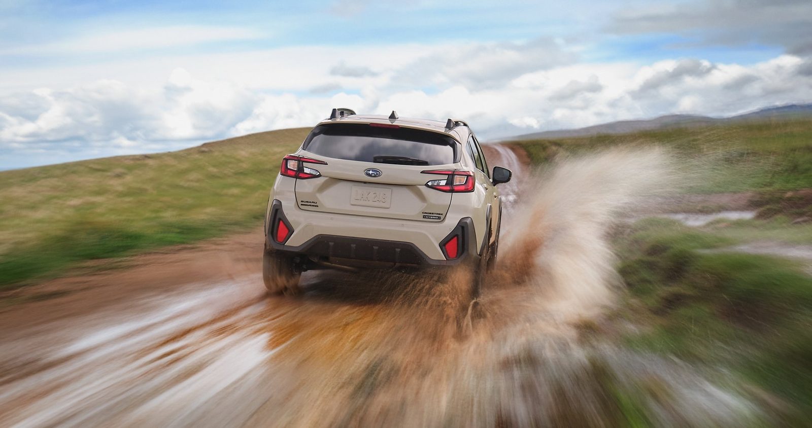 Subaru Crosstrek Hybrid 2026 - exterior, rear 3q driving mud, US / EV Query only market